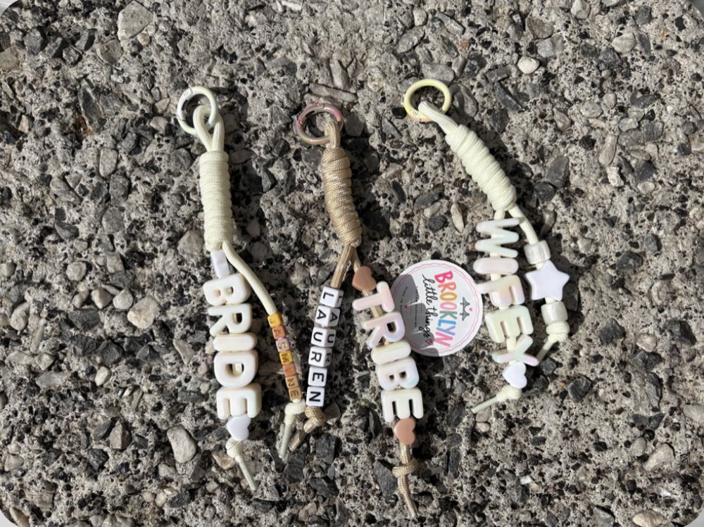 Bridal party keychains spelling Bride, Tribe, Lauren and Wifey with small square letter beads